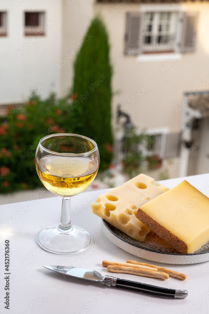 Cheese collection, hard French cheese comte made from cow milk with rind in Franche-Comte regio and emmentaler cheese, France, served with white wine