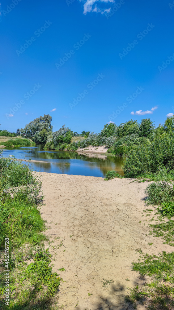 Landscape with a lake and clouds in the sky in the summer season