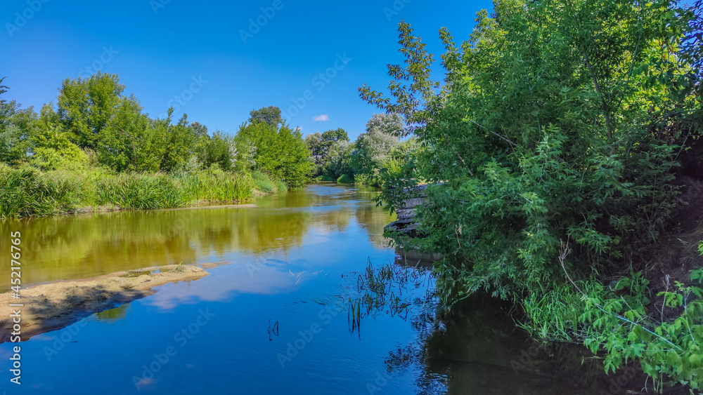 Landscape with a lake and clouds in the sky in the summer season