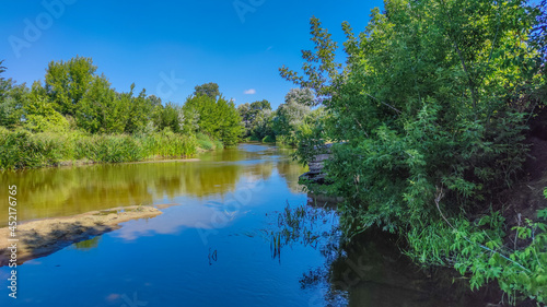 Landscape with a lake and clouds in the sky in the summer season