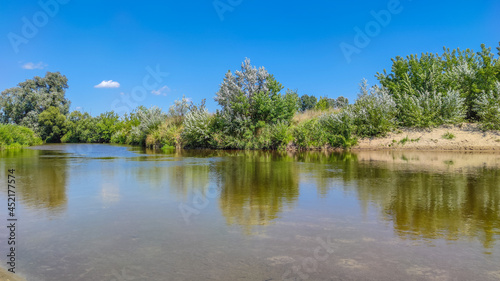 Landscape with a lake and clouds in the sky in the summer season