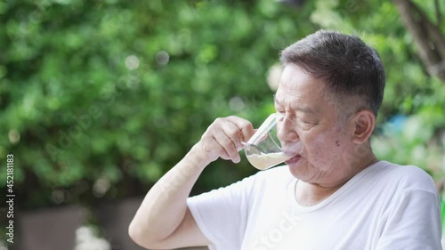 senior asian man drinking tea in morning