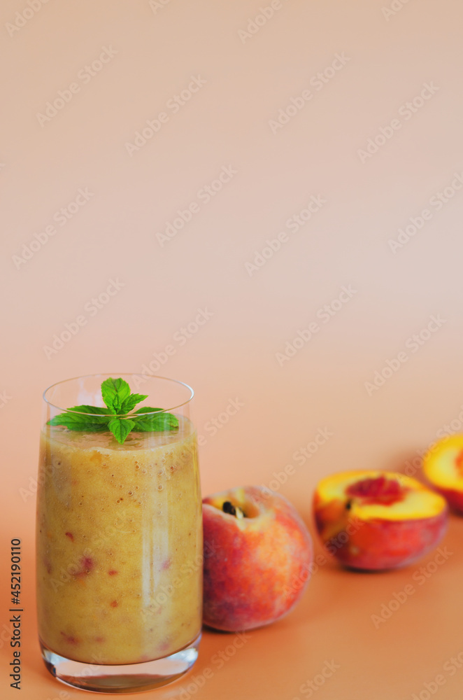 Top view of fresh healthy smoothie in a glass made of peach, banana and berries. Creative concept of healthy detox drink, diet or vegetarian food concept. Copy space. Top view of fresh healthy smoothie in a glass made of peach, banana and berries. Creative concept of healthy detox drink, diet or vegetarian food concept. Copy space.