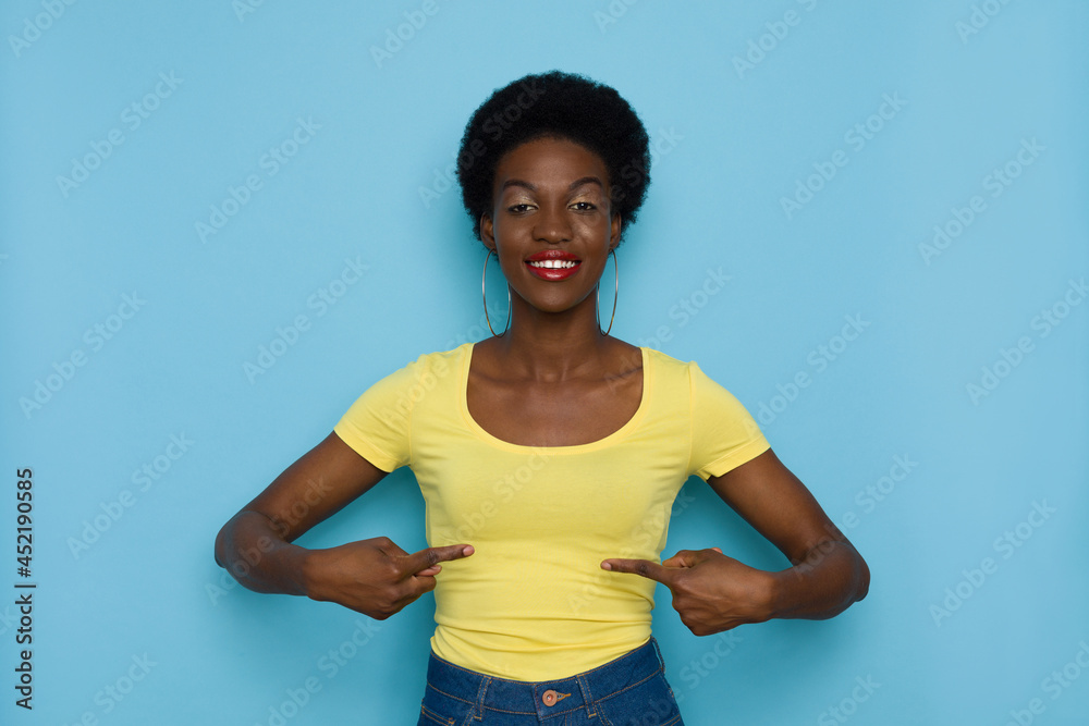 Confident Black Woman Is Pointing At Her Yellow Shirt. Confident Black Woman Is Pointing At Her Yellow Shirt.