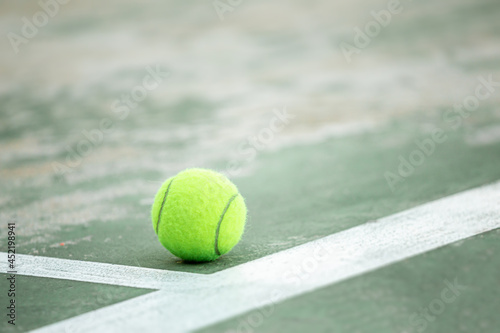 A tennis ball that falls on a tennis court, landing on the court scores a point , Sports background with tennis concept © NARANAT STUDIO