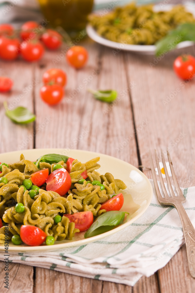 Fusilli pasta with cherry tomatoes and peas. Fusilli pasta with cherry tomatoes and peas.