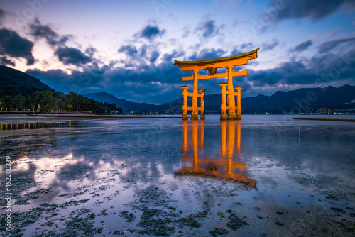 Red torii gate of the Itsukushima Shrine on Miyajima island, Japan photo