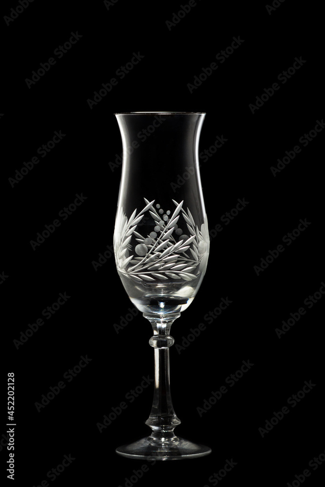 An empty champagne glass on a black background. An empty champagne glass on a black background.