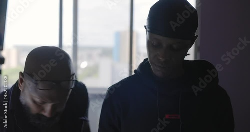 Tattoo artist working with client