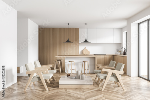 White and beige kitchen with seating area and two black pendant lamps