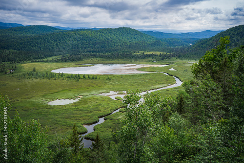 View on the Valin river and the Valin Mountain in summer from the Mirador hiking trail in Monts Valin National Park, in Quebec (Canada) photo