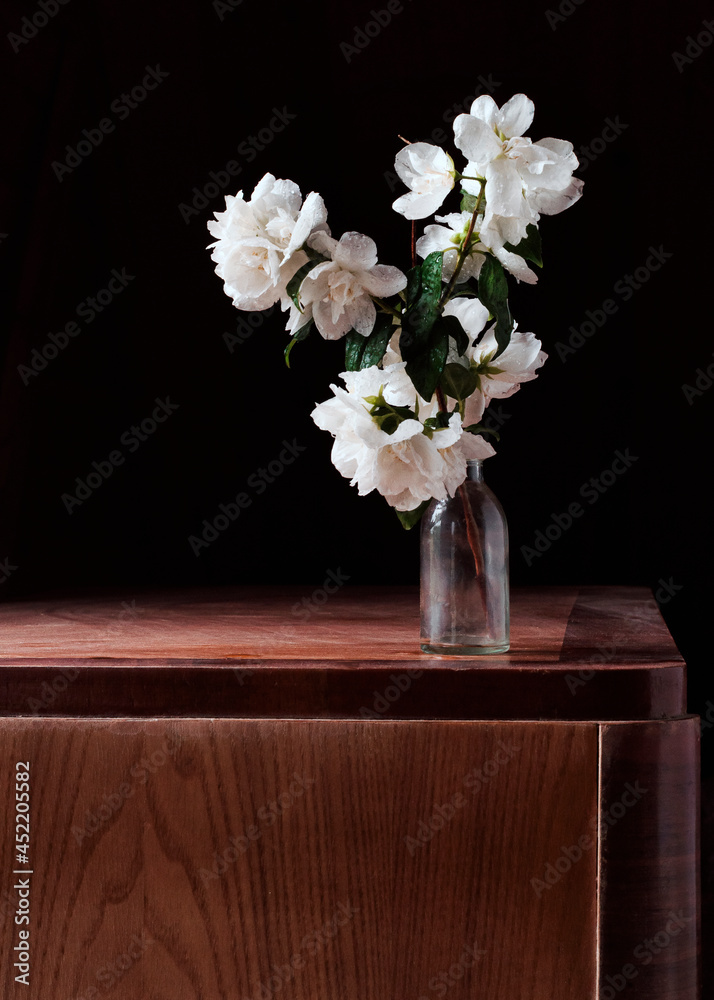 Still life with jasmine in a bottle. Vertical orientation Still life with jasmine in a bottle. Vertical orientation