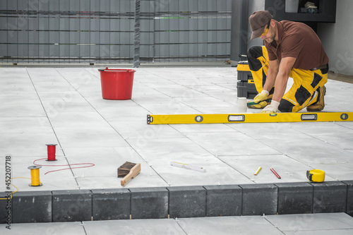 Outdoor Patio Tiles Installation by Professional Worker photo