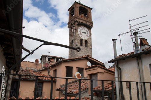 Lucca city center, Italy .View of the old clock tower with house terrace
