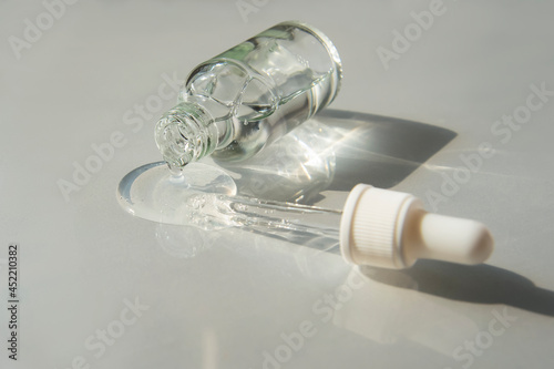 Bottle of Hyaluronic acid gel with pipette on light grey background. Trendy selfcare products