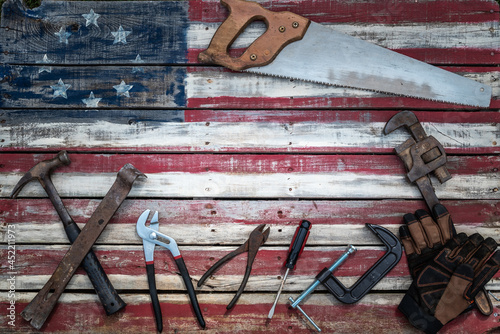 Betsy Ross American flag from wood pallet  with metal tools as saw, hammer, and wrench photo
