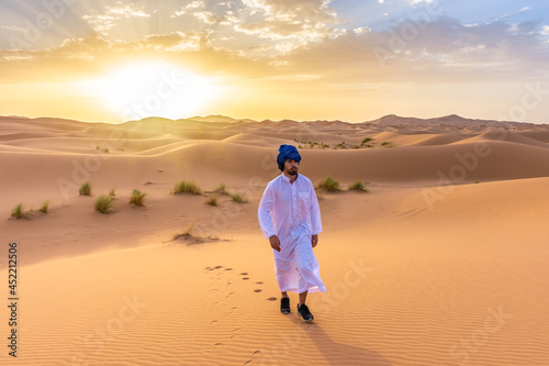 Berber man wearing traditional clothes in the Sahara Desert at dawn  Morocco