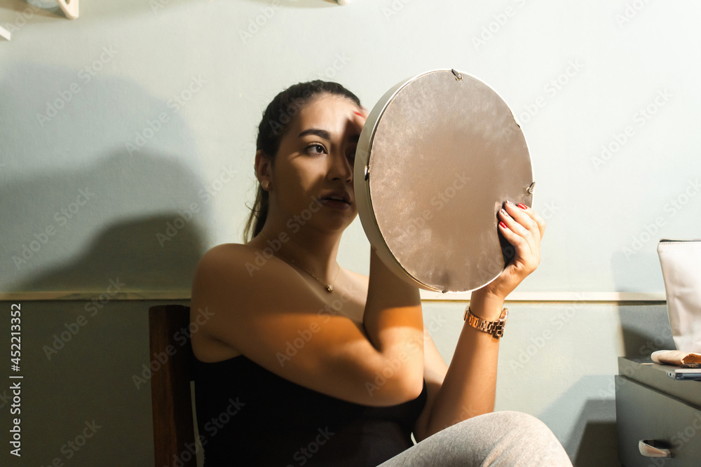 Naklejka premium Girl wiping her face to start making up in her room.