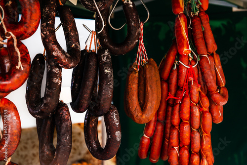 Typical Spanish sausages hanging on a village stall at the food market