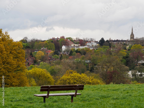 Bench on Hampstead Heath with Highgate in the background, London, UK