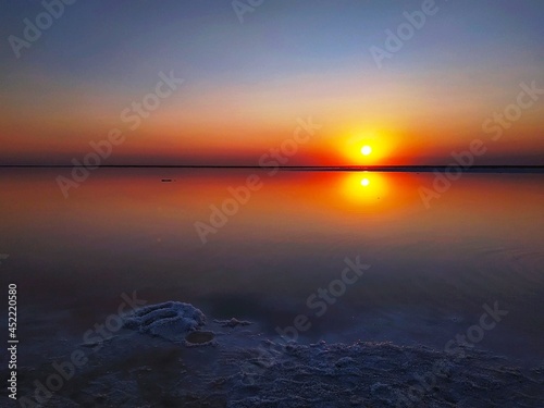Colorful sunset on pink lake in Ukraine. The area of salt extraction for healthy cosmetic.