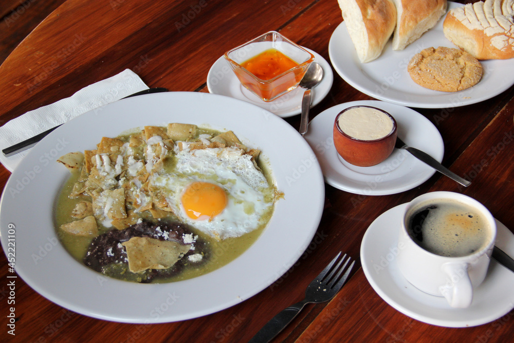 Delicious Mexican breakfast with coffee, sweet bread, beans