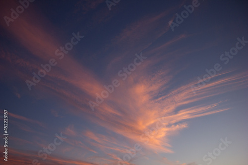 A wide shot of a dramatic orange and blue sunset or sunrise sky