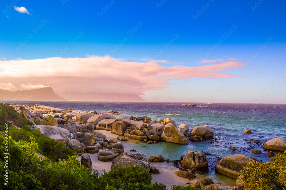 Boulders is a turqoise rocky and sheltered beach in cape town taken as sunset