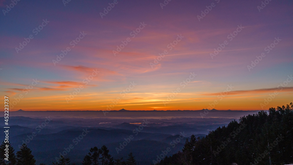 Oregon Cascade Range and  the Willamette Valley at sunrise as seem from Marys Peak in the Oregon Coast Range.