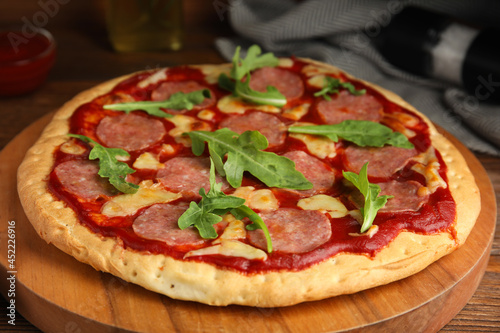 Delicious homemade pita pizza on wooden board, closeup
