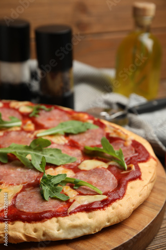 Delicious homemade pita pizza on wooden board, closeup