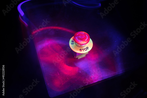 Emergency stop button, Disaster protection. Industrial concept. Red button on table in dark low key background.