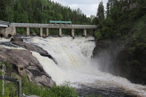 waterfall in the mountains with a bridge