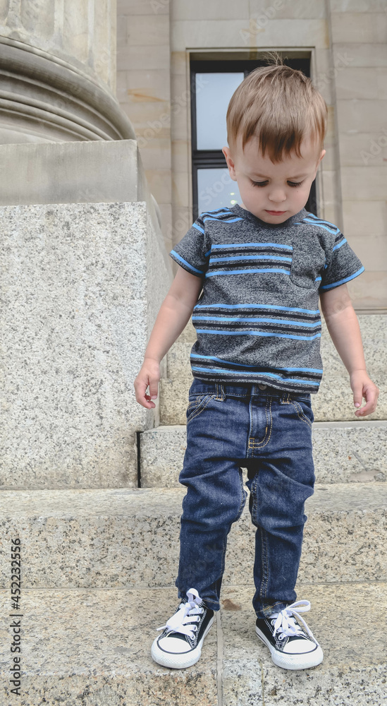 little child playing on stone steps little child playing on stone steps