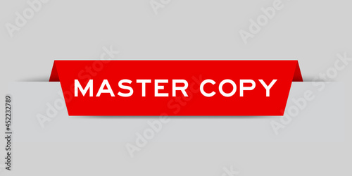 Red color inserted label with word master copy on gray background