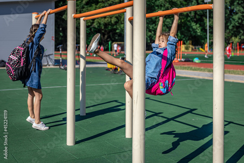 Billede på lærred Elementary school students playing on the school playground.