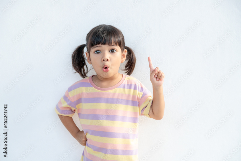 Asian student girl over white background pointing finger up with a successful idea. Excited and happy. Number one. Asian student girl over white background pointing finger up with a successful idea. Excited and happy. Number one.
