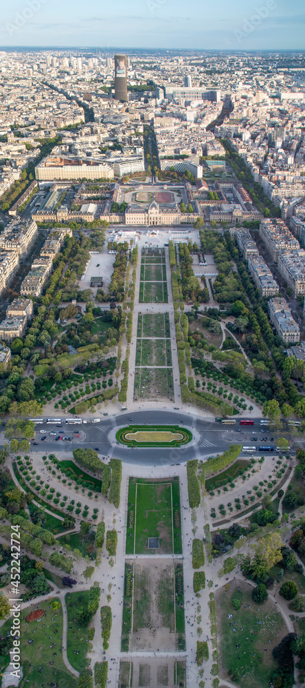 A vertical panoramic view of Champs des Mars field in Paris, France, as seen from atop the Eiffel Tower during sunset.