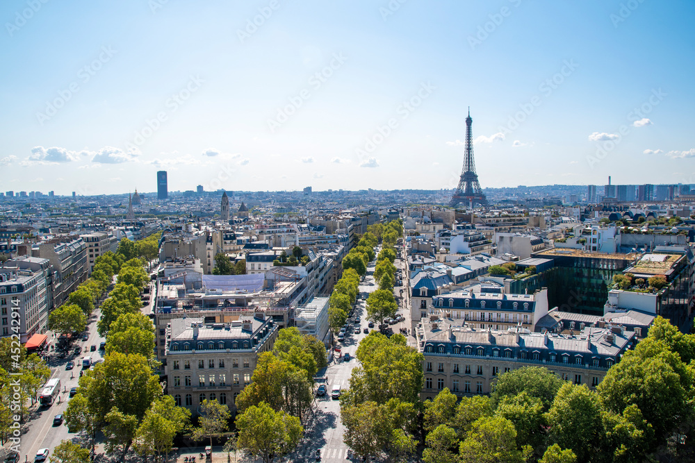 A view of the Paris cityscape as seen from atop the Arc de Triomphe on a beautiful sunny day.