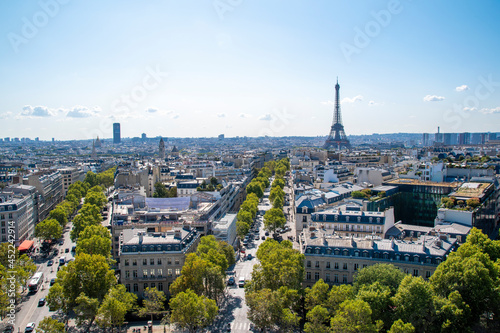 A view of the Paris cityscape as seen from atop the Arc de Triomphe on a beautiful sunny day.