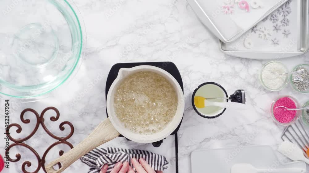 Flat lay. Step by step. Caramelizing sugar in a small cooking pot over the small electric stove. Flat lay. Step by step. Caramelizing sugar in a small cooking pot over the small electric stove.