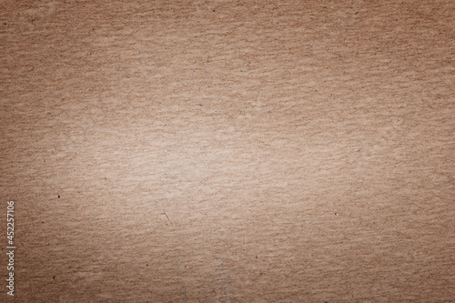brown cardboard background with a light spot in the middle