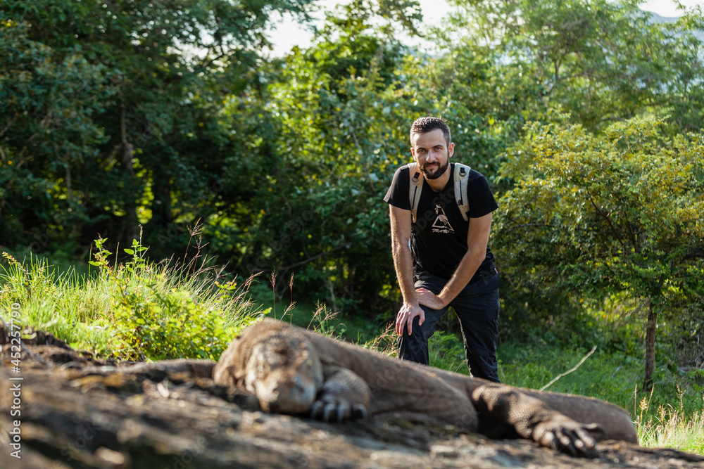 A man standing next to Komodo dragon A man standing next to Komodo dragon