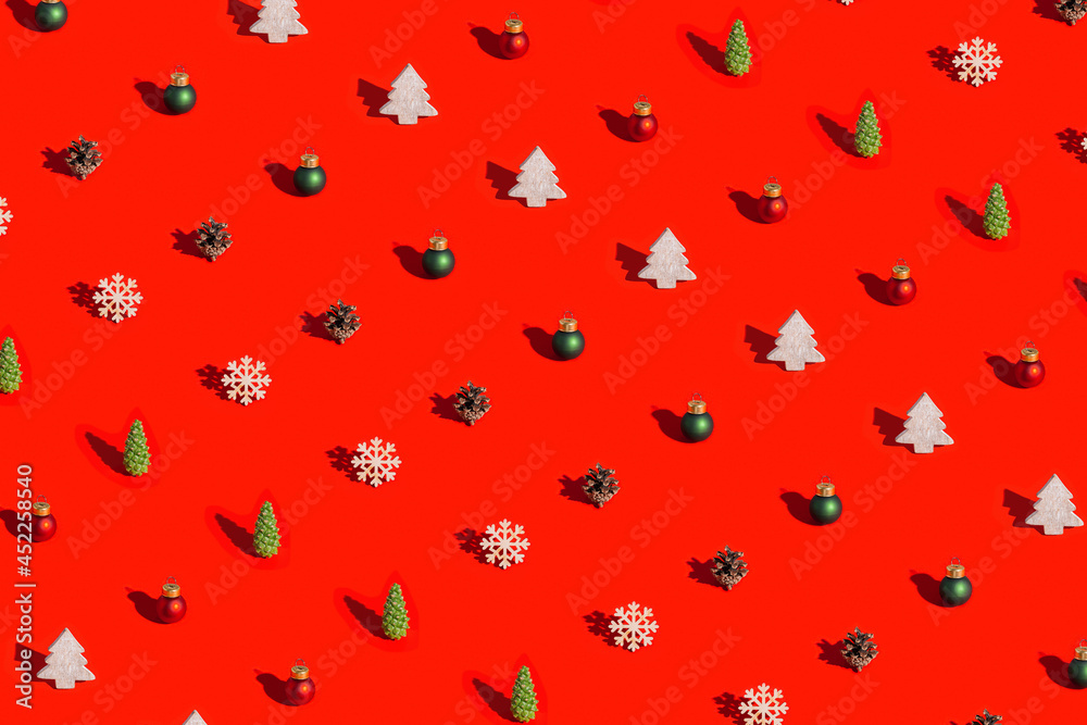 Christmas layout with natural decorations, wooden snowflake and christmas tree, pine cone on red background. Christmas layout with natural decorations, wooden snowflake and christmas tree, pine cone on red background.