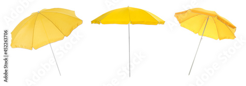 Set with yellow beach umbrellas on white background. Banner design photo