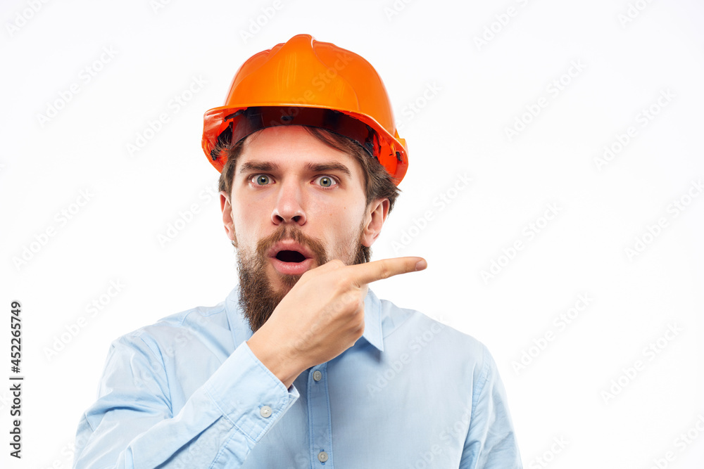 emotional man orange helmet on the head Studio hand gesture emotional man orange helmet on the head Studio hand gesture