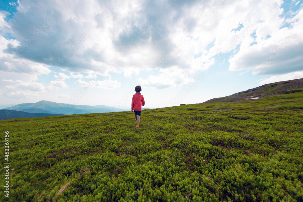 boy walks along a mountain path..