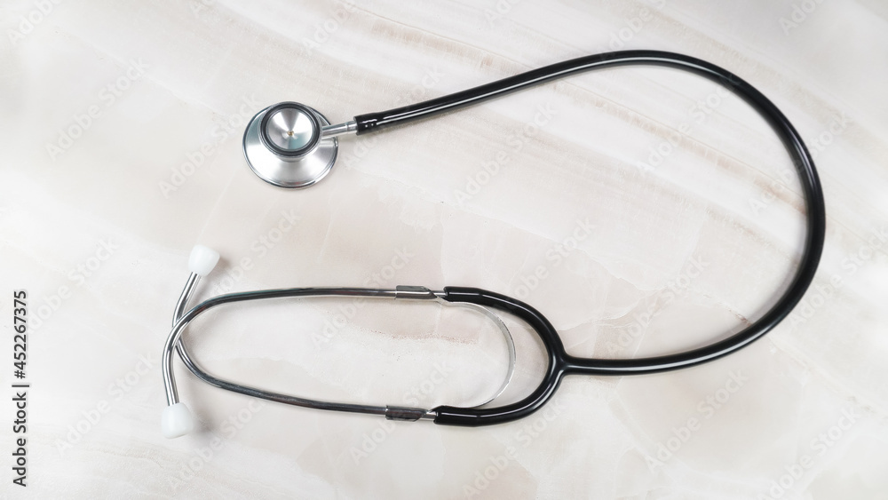Stethoscope for medical on marble desk in hospital. Health care concept. Top view. Stethoscope for medical on marble desk in hospital. Health care concept. Top view.