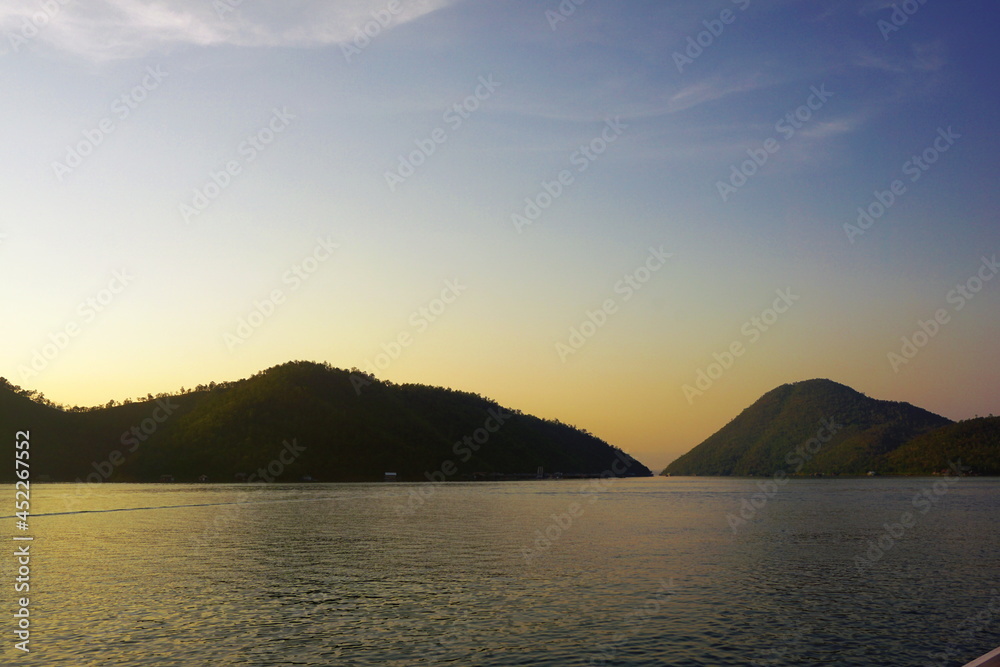 mountains in the lake thailand with sunset
