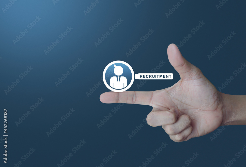 Businessman with magnifying glass icon on finger over light gradient blue background, Business recruitment concept Businessman with magnifying glass icon on finger over light gradient blue background, Business recruitment concept
